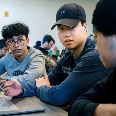 WATERVILLE, ME – JANUARY 11: Josh Kim (center) ’23, a computer science and anthropology major, works with Pramithas Upreti (right) ’26, a computer science major, and Narit Trikasemsak ’25, a computer science and economy major, and on their artificial intelligence project during their Hands-on Computer Vision class in Diamond Building, Wednesday, January 11, 2023. Kim, co-founder of The Cubby, a successful online marketplace that began in 2019, is forging his next chapter as a student-entrepreneur. He took a year off and is back at Colby to finish his senior year. (Photo by Ashley L. Conti)