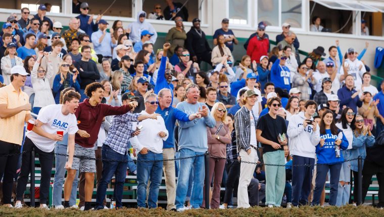 Fans cheer excitedly at a Colby football game during Homecoming