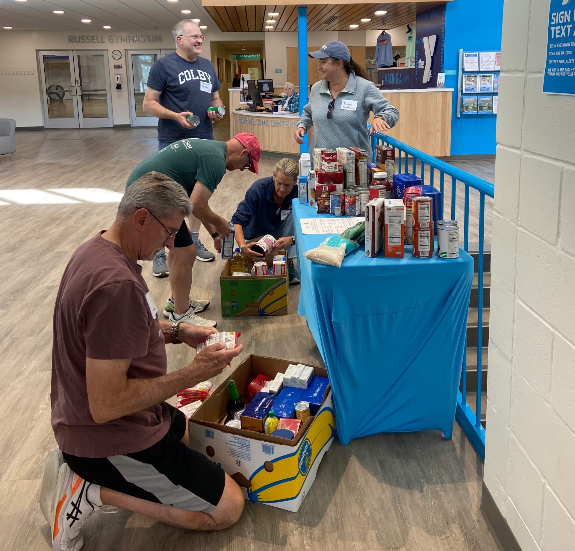 Volunteers work to organize food for the Boothbay Food Pantry during Colby Alumni Day of Service 2025.